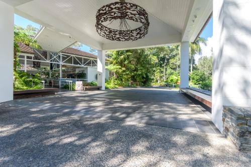 an empty porch of a house with a chandelier at Seascape Holidays at Ramadaresort in Port Douglas