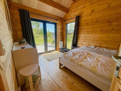盖瑟Charming Holiday Home Near The Beach的木屋里有一张床的卧室