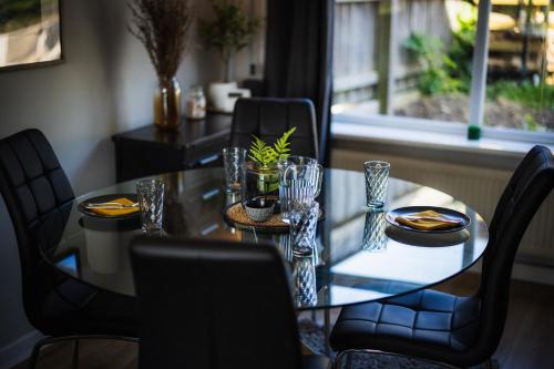 a dining room table and chairs with a table and a table and a window at Home from home in Gilesgate