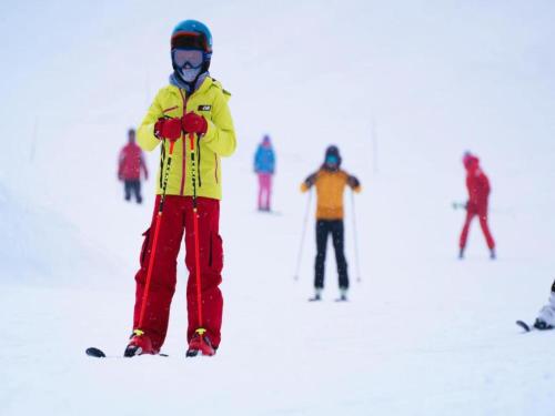a young child standing on skis in the snow at Relaxing Poolside Alpine Apt in Vallorcine