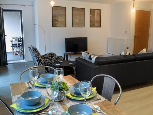 a living room with a table and a couch at Alnwick Malthouse in Alnwick