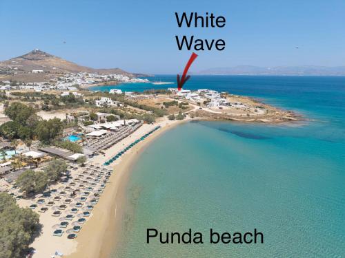a view of a beach with the words white wave and puma beach at White Wave in Logaras