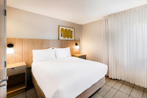 a large white bed in a hotel room at Sonesta Simply Suites Birmingham Hoover in Birmingham