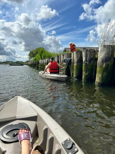 two people on a boat in the water at Protected Fjord Cabin With Fjord Views in Randers