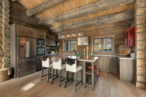 a kitchen with wooden walls and a wooden ceiling at Cabin With Panoramic View Over Hardangervidda in Dagali