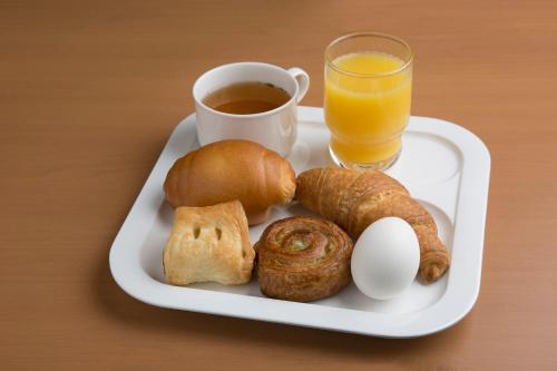 a plate of breakfast foods with a cup of coffee and orange juice at R&B Hotel Kobe Motomachi in Kobe