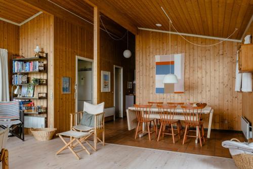 a dining room with a table and chairs at Warm 70S Vibe Near Limfjord in Løgstør