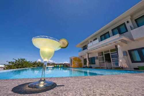 a martini glass sitting next to a swimming pool at Lime Hotel Boracay in Boracay