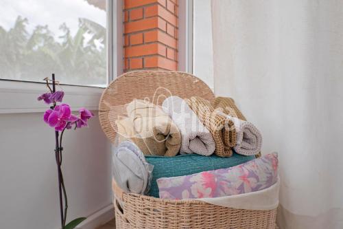 a wicker basket filled with towels and a window at Villa Bio Finca With Pool in Playa Paraiso
