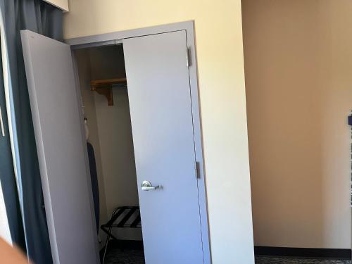 a closet with a door in a room at Tapa Hotel, Inn & Suites in Mahwah