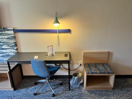 an office with a desk and a chair and a lamp at Tapa Hotel, Inn & Suites in Mahwah