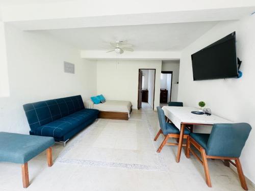 a living room with a couch and a table at Vistas a las Montañas y al Mar I Condominio Las Calandrias I Alberca I Wi-Fi in Ixtapa