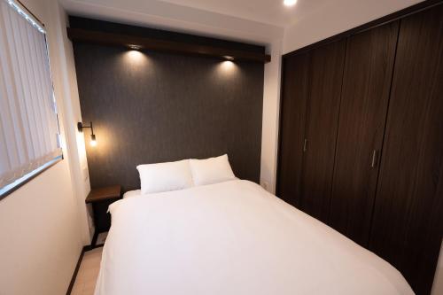 Ένα ή περισσότερα κρεβάτια σε δωμάτιο στο Apartment Hotel MODISH Gion