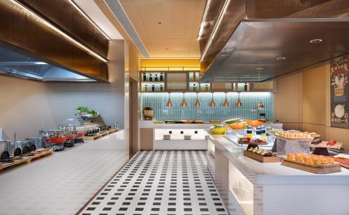 a restaurant with a buffet line with food at Hilton Garden Inn Xingyi Orange Hill Plaza in Xingyi