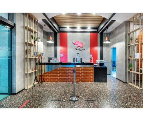 a lobby of a store with a pink pig on the wall at PLAAI Plus Hotel Rayong in Rayong