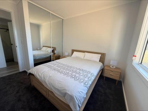 a bedroom with a large bed with a mirror at Koolywurtie in Pine Point