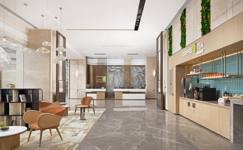 a lobby of a store with chairs and tables at Hilton Garden Inn Xingyi Orange Hill Plaza in Xingyi
