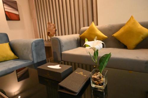 a living room with a couch and a coffee table at فندق امان أبها - المعالي in Abha