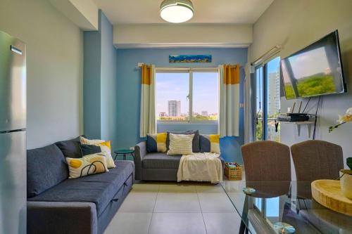 a living room with a couch and a window at Caribbean Nature Sourrounded Refuge Apartment in Juan Dolio