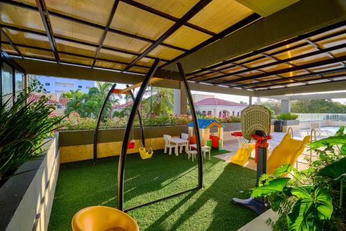 a patio with a play area with a playground at Caribbean Nature Sourrounded Refuge Apartment in Juan Dolio