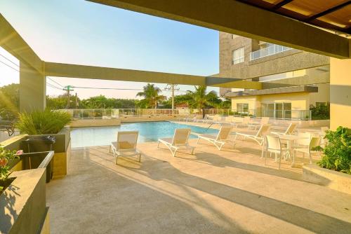 a patio with chairs and a swimming pool at Caribbean Nature Sourrounded Refuge Apartment in Juan Dolio