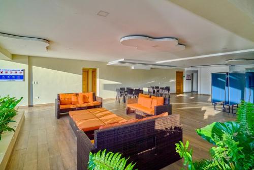 a lobby with couches and tables and chairs at Caribbean Nature Sourrounded Refuge Apartment in Juan Dolio