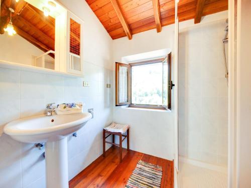 a bathroom with a sink and a window at Belvilla by OYO Farmhouse with Private Terrace in Bagni di Lucca