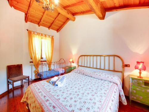 a bedroom with a bed and a chair at Belvilla by OYO Farmhouse with Private Terrace in Bagni di Lucca