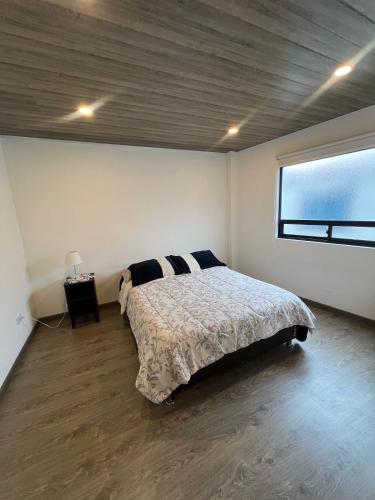 a bedroom with a bed in a room with a window at Apto Prados de San Jorge #2 in Guatavita