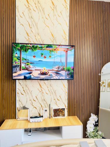 a flat screen tv sitting on a wall at Pure Bliss Getaway Condo Near Mactan Airport Lapu-Lapu in Lapu Lapu City