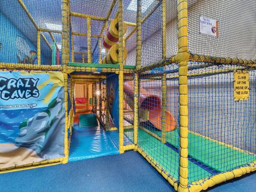 a play room with a play structure with a play floor at Harbour Haven - Hayling Island in South Hayling