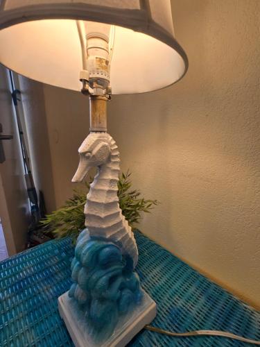 a lamp with a seahorse on a table at Sunset Cove - Water View in Sarasota