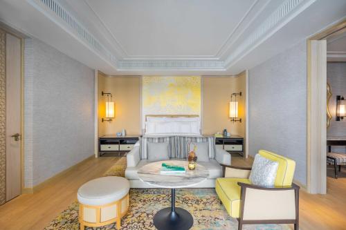 a bedroom with a bed and a living room at InterContinental Phuket Resort by IHG in Kamala Beach