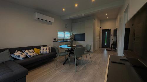 a living room with a couch and a table at Krastos - māja Breksis in Aizkraukle