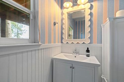 a bathroom with a sink and a mirror at Yosemite family getaway w lake, golf, horses, pool in Groveland