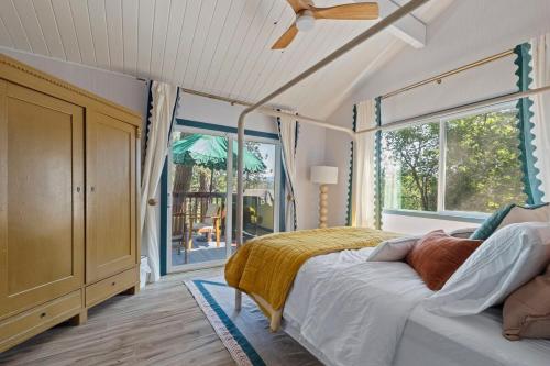 a bedroom with a bed and a large window at Yosemite family getaway w lake, golf, horses, pool in Groveland
