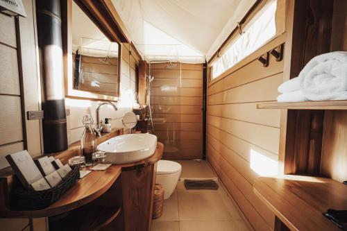 a bathroom with a sink and a toilet at Glamp Nusa in Nusa Dua