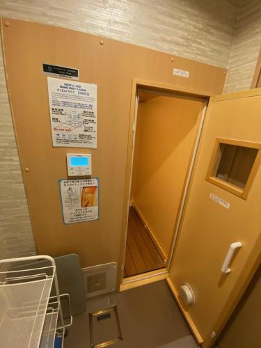 a hospital room with an open door to a room with a bed at Rokko Outdoor Station FOTON in Kobe