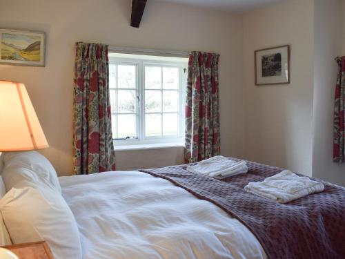 a bedroom with a bed with two towels on it at Royal Oak Farm in Winsford