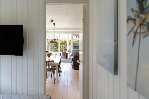 a hallway leading to a dining room and living room at Tiny House Vibe At Beach Near Saksild Home in Odder