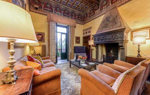 a living room with couches and a fireplace at Awesome Home In Campiglia Marittima in Campiglia Marittima