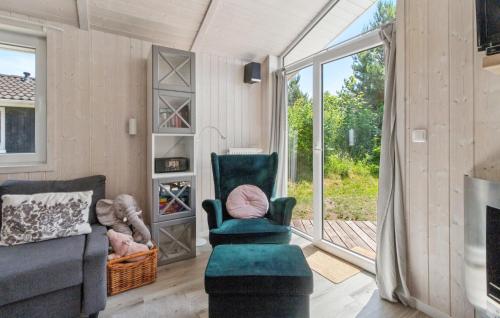 a living room with a couch and a chair and a window at Dünenpark 2B - Dorf 4 in Priwall
