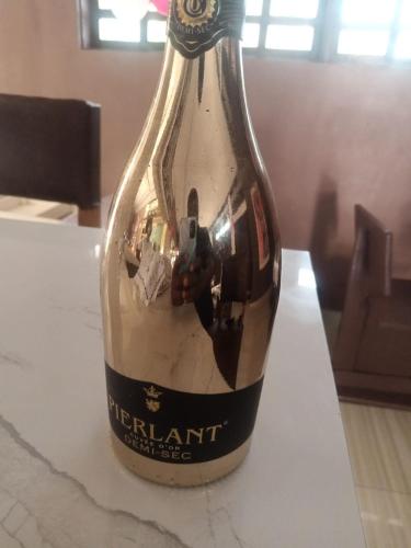 a bottle of wine sitting on top of a table at ASVA BEACH Resort in Grand-Popo