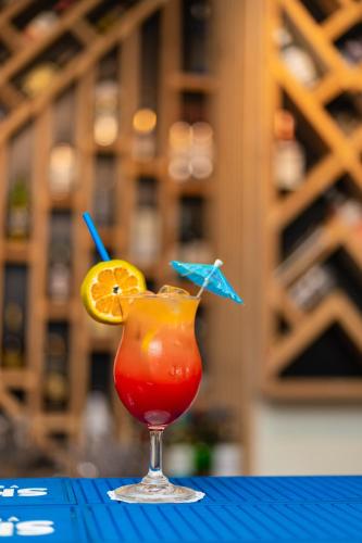 a drink with an orange slice in a glass at Hotel Gangotri Pvt Ltd in Bharatpur