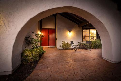 an archway leading to a patio with a red door at 5 Bedroom Home With Firepit in San Diego