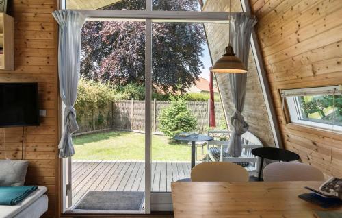 a living room with a sliding glass door to a patio at 1 Bedroom Cozy Home In Væggerløse in Bøtø By