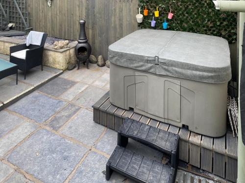a dog bed sitting on a patio with a chair at Wild Duck in Pennington