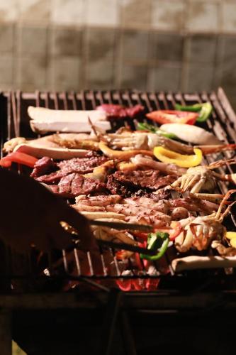 a bunch of meat and vegetables on a grill at Wonderland Suites and Resort in Sihanoukville