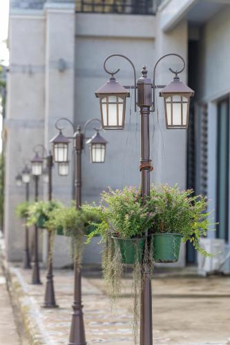 a row of lights with potted plants on a street at Wonderland Suites and Resort in Sihanoukville
