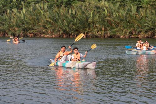 a group of people in kayaks on the water at Wonderland Suites and Resort in Sihanoukville